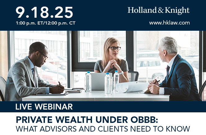 Three people sitting at a table with paperwork