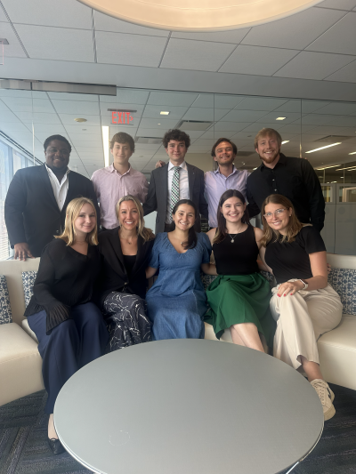 Group of people standing around a circular table
