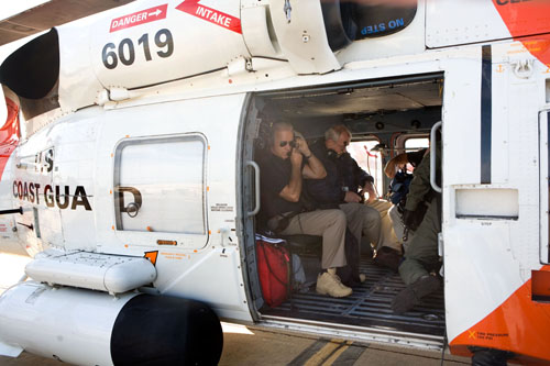 Vice President Joe Biden adjusts his microphone on board an US Coast Guard Helicopter before taking off to survey flood damage in Marietta, Georgia.Official White House Photo by David Lienemann