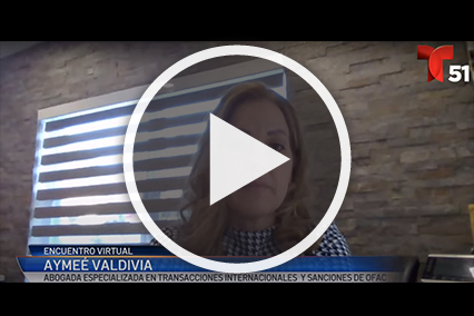 Woman in front of brick wall with window