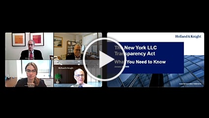 Four people on screen with white play button overlay