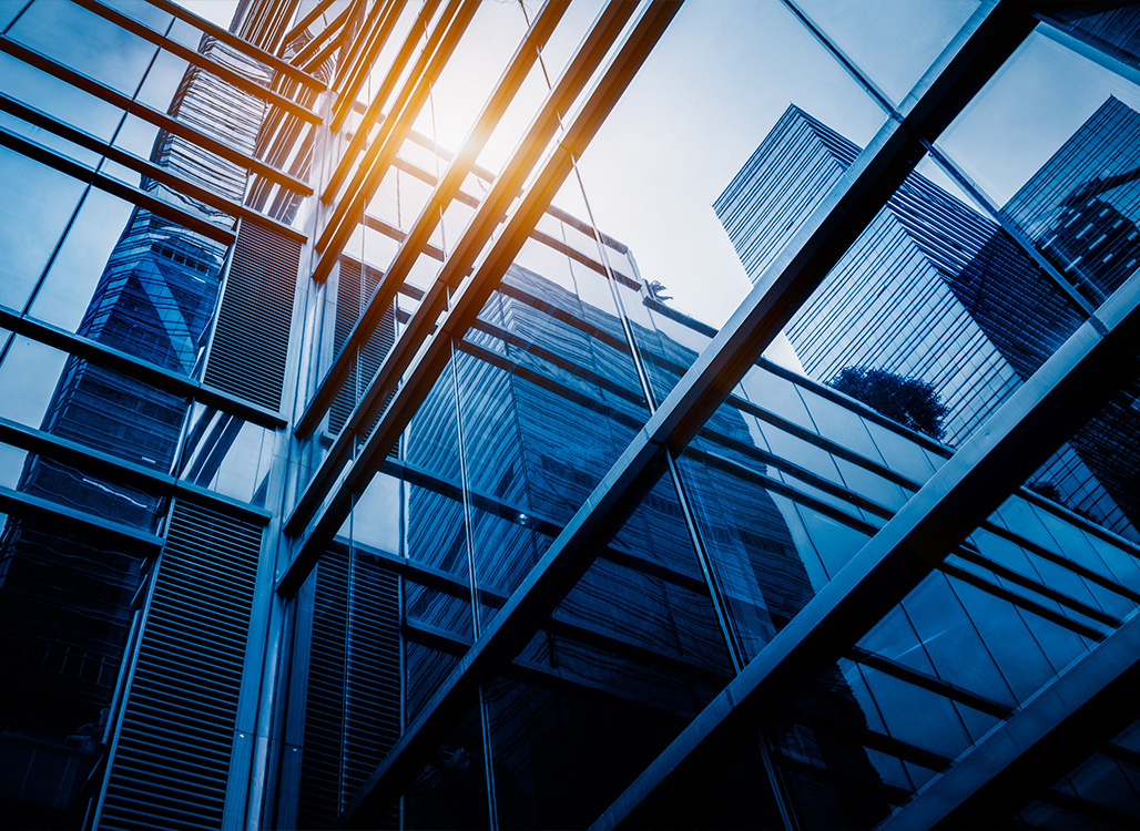 Blue glass building with yellow sunlight