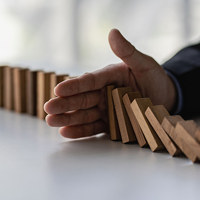 Hand blockng falling domino pieces