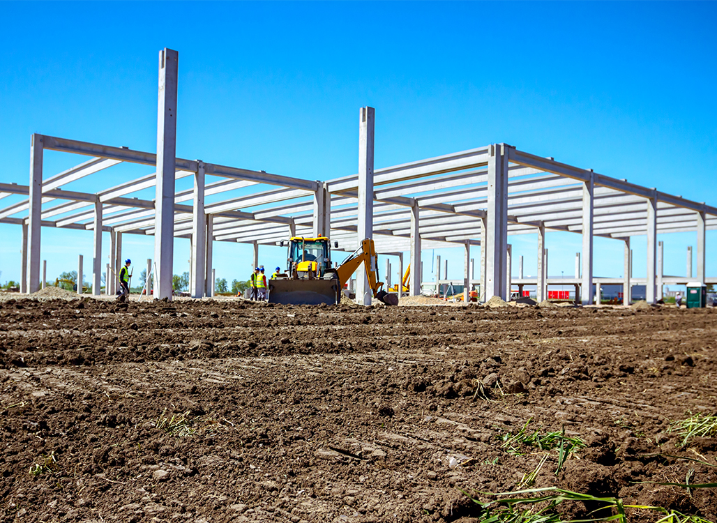 Construction beams in dirt field