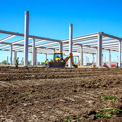 Construction beams in dirt field