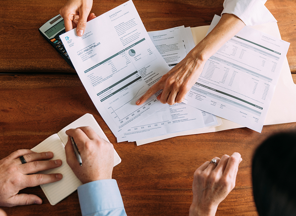 Paperwork and hands holding pen