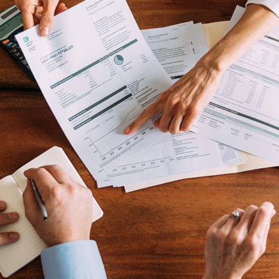 Paperwork and hands holding pen