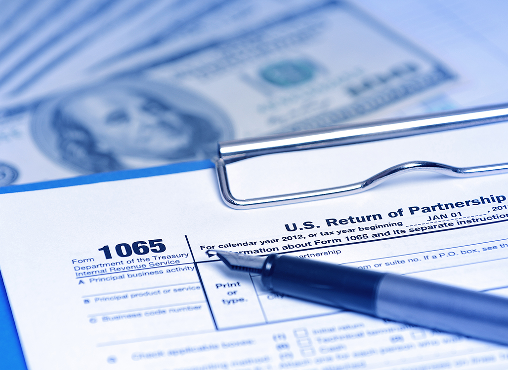 Form on clipboard with blue pen