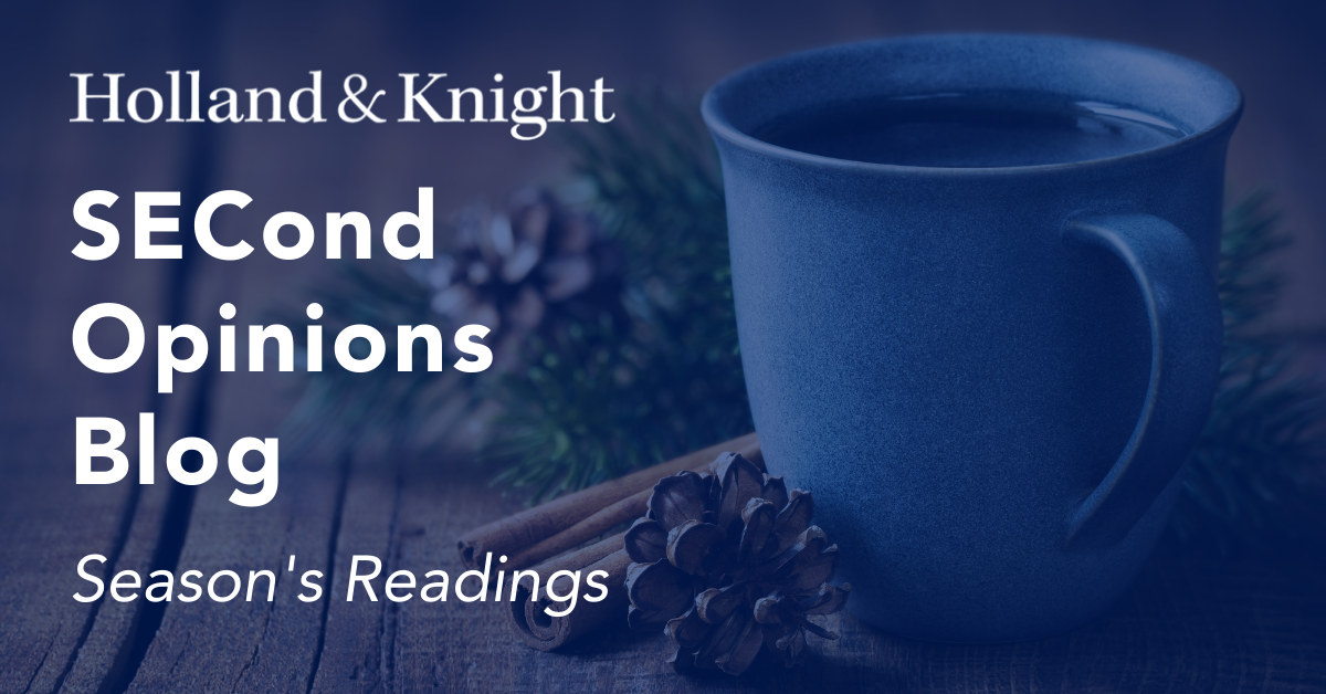 White mug of coffee with cinnamon stick and pine cone next to it